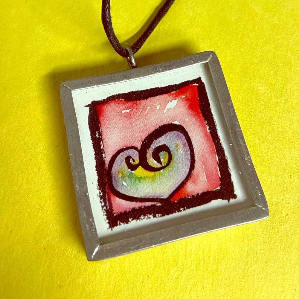 Metal and glass necklace with heart design.